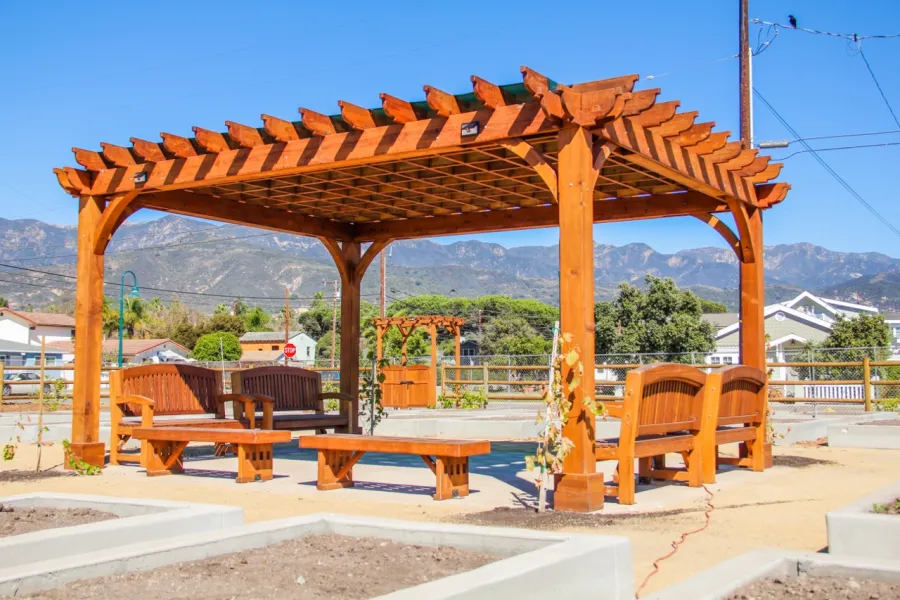 Montvale Pergolas (Options: 16' x 20', Mature Redwood, 4-Post Anchor Kit for Concrete, No Ceiling Fan Base, No Curtain Rods, No Privacy Panels, 9.5' Post, Transparent Premium Sealant). Photo also shows some Luna Memorial Benches and Lighthouse Benches. Sunbrella shade fabric above the pergola was ordered from: www.patiolane.com as a custom item. Photo Courtesy of Carpinteria Park, 5775 Carpinteria Avenue  Carpinteria, CA  93013.
