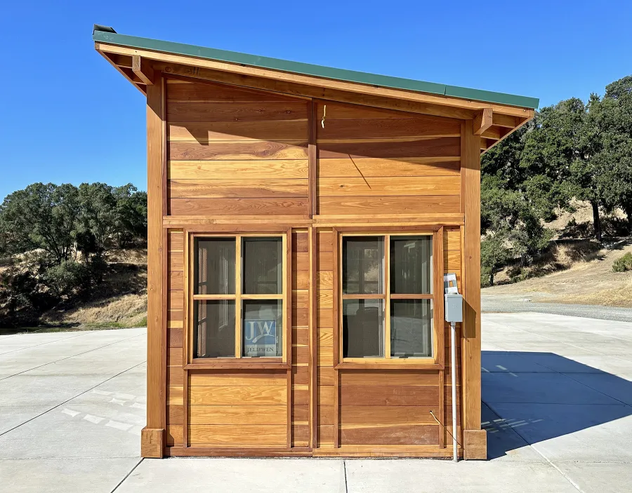 Palo Alto Backyard Cabin (Options: 10' L, 12' W, Without Porch, California Redwood for Exterior Finished, Douglas-fir Internal Walls and Framing, With 2 French Doors, Slidding Windows, Windows Purchased Locally, With 4' x 4' Skylight, Metal Roof, Electrical Wire Trim on the Walls, Transparent Premium Sealant). Photo Courtesy of M. Diaz of Fairfield, CA.
