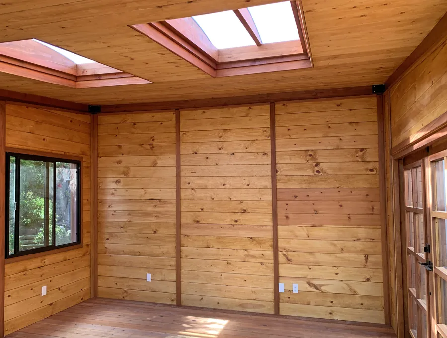 Palo Alto Backyard Cabin (Options: 18' L, 16' W, Without Porch, Structural Deck - Interior and 4' Exterior, California Redwood, Sugar Pine Internal Walls and Ceiling, Windows Purchased Locally, With Two 3' x 5' Skylights, Metal Roof, Custom Railings and Steps, Electrical Wire Trim on the Walls, Transparent Premium Sealant). Photo Courtesy of A. Ramon of South San Francisco, California.