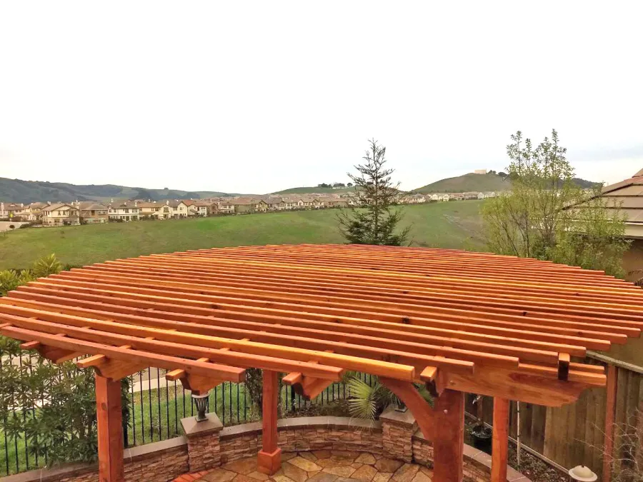 Round Pergola (Options: 16' Diameter, No Privacy Panel, California Redwood, Open Roof Slats at 6", 9.5ft Post Height, Include Electrical Wiring Trim for 2 Posts, 4-Post Anchor Kit for Stone, No Post Decorative Trim, No Ceiling Fan Base, No Curtain Rods, Transparent Premium Sealant). Photo courtesy of Harish B. of Dublin, CA