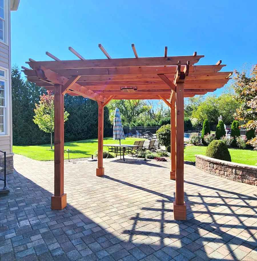 Round Pergola (Options: 16' Diameter, No Privacy Panel, California Redwood, Open Roof Slats at 18", 9ft Post Height, Include Electrical Wiring Trim for 2 Posts, 4-Post Anchor Kit for Concrete, No Post Decorative Trim, 1 Ceiling Fan Base, No Curtain Rods, Transparent Premium Sealant). Photo courtesy of J. Holobinko of Hagerstown, MD.