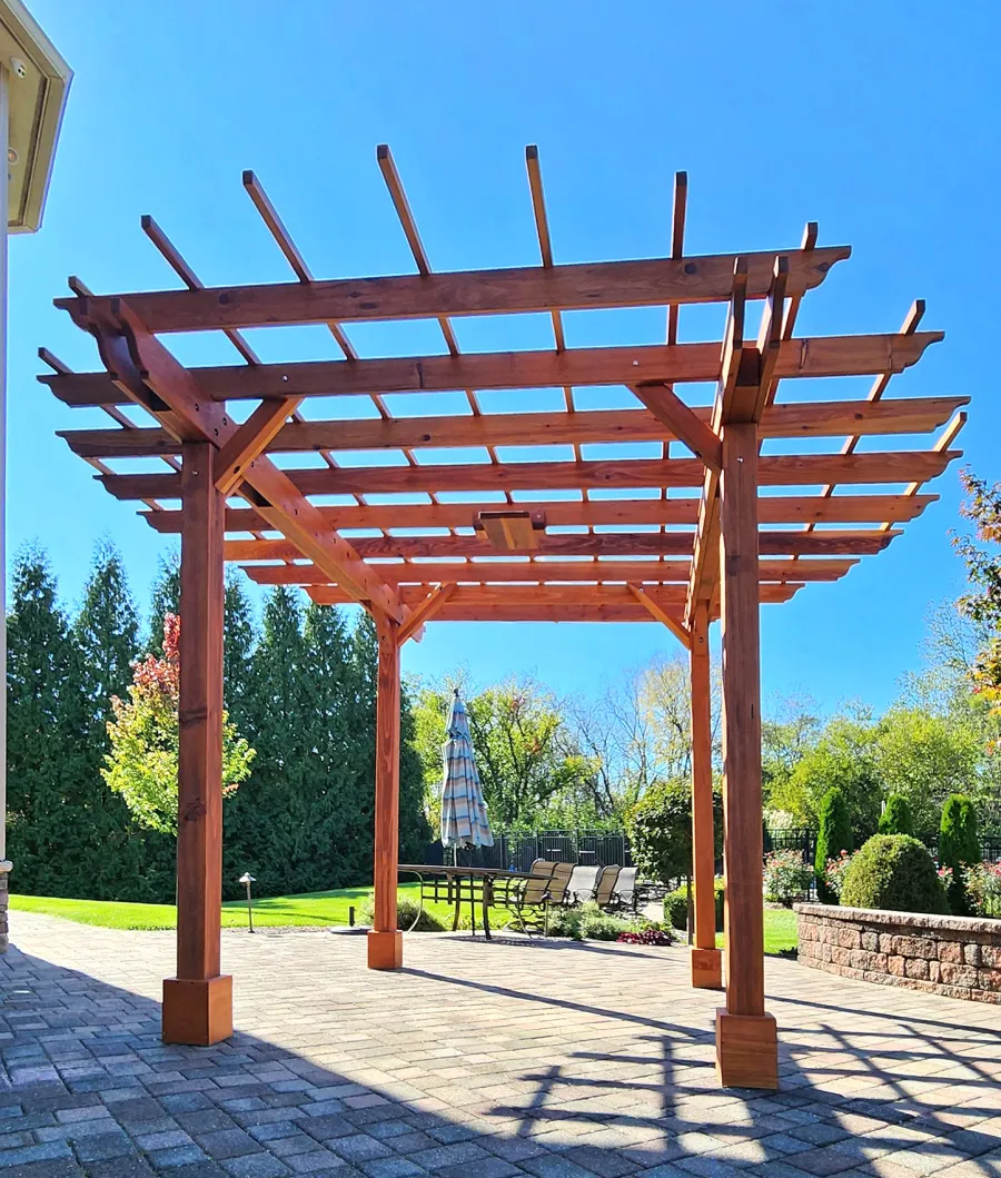 Round Pergola (Options: 16' Diameter, No Privacy Panel, California Redwood, Open Roof Slats at 18", 9ft Post Height, Include Electrical Wiring Trim for 2 Posts, 4-Post Anchor Kit for Concrete, No Post Decorative Trim, 1 Ceiling Fan Base, No Curtain Rods, Transparent Premium Sealant). Photo courtesy of J. Holobinko of Hagerstown, MD.
