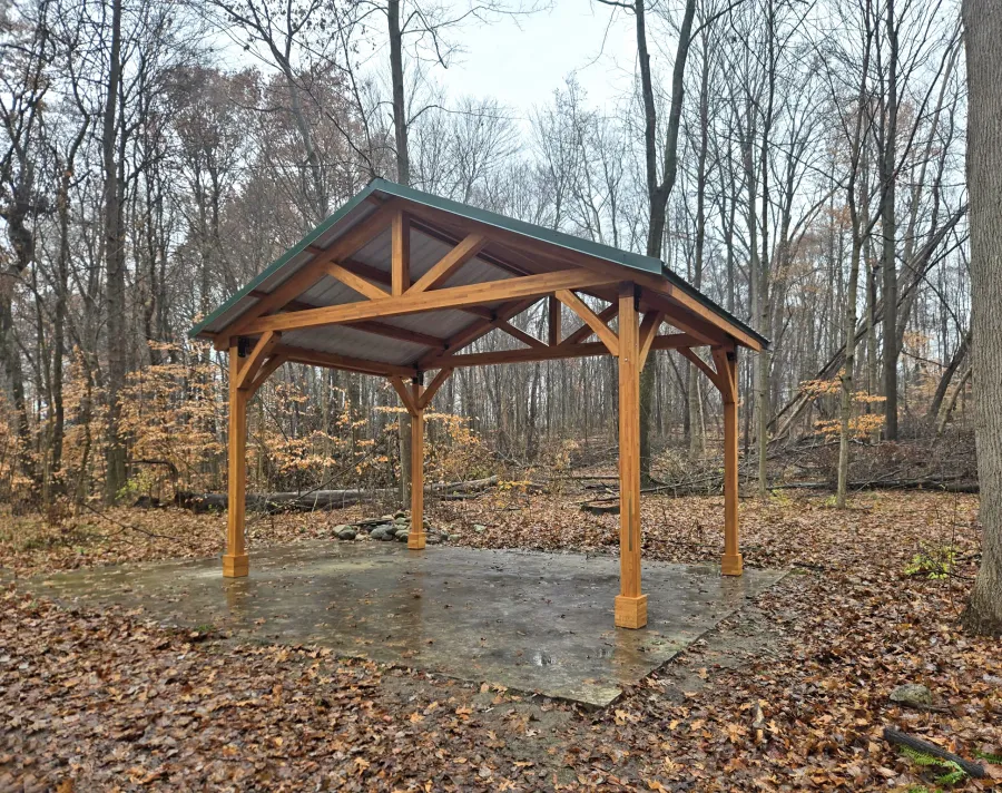 San Carlos Carport Pavilion (Options: 14' L x 20' W, Mosaic Douglas, Post Standard Anchor Kit, 9.5' H Posts, 6x6 Posts, Electrical Wiring Trim Kit for 1 Post, Transparent Premium Sealant). Pavilion installed at Love Creek County Park, 9292 Huckleberry Rd #9736, Berrien Center, MI.
