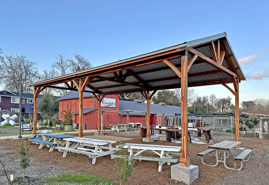 San Carlos Carport Pavilion (Options: 40' L x 20' W, Mosaic Redwood, 6- Post Stainless Steel High Wind Anchor Kit, 10' H Posts, 6x6 Posts, Electrical Wiring Trim Kit for 1 Post, Transparent Premium Sealant). Order installed at Bayer Park Gardens, 1550 West Ave. Santa Rosa, CA.