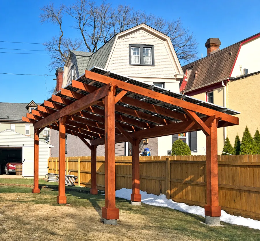 Solar Pergola (Options: 26' x 13' 8", Mature Redwood, Oversize Timbers by Custom Request, 6-Post Anchor Kit for High-Wind, Transparent Premium Sealant). Solar Panels Installed by Customer. Photo Courtesy of M. Guzzetta of Pittsburgh, Pennsylvania.