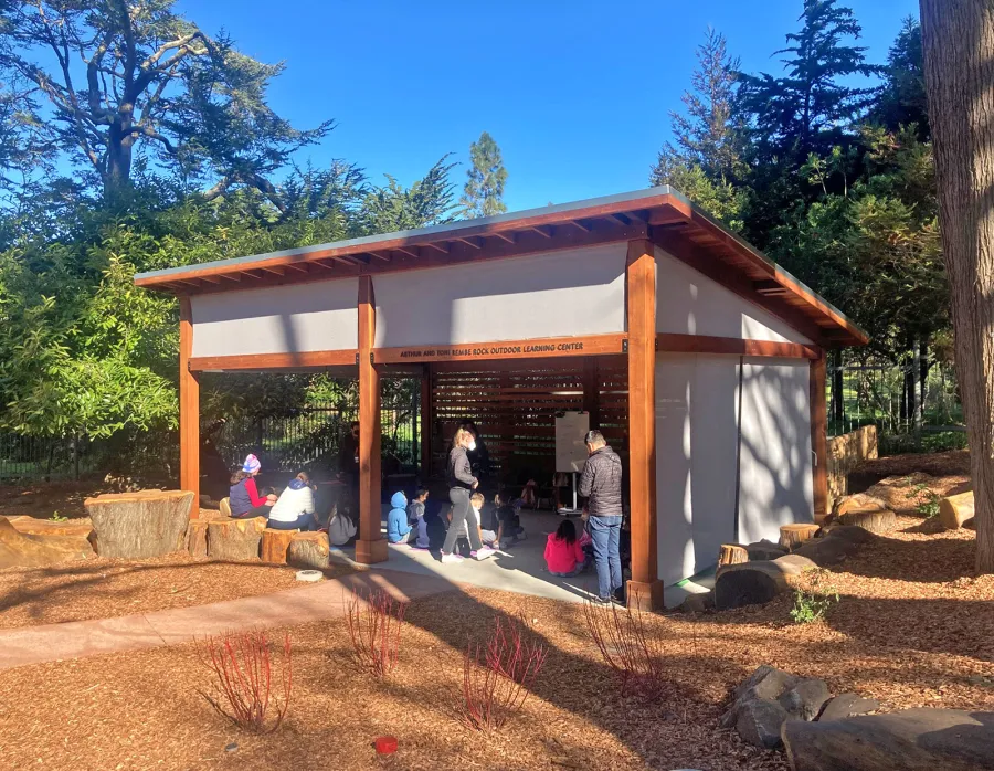 Custom Sunset Patio Pavilion (Options: 28' x 18', 1 Fixed Louvered Privacy Wall, California Redwood, No Electrical Wiring Trim, 6-Post Anchor Kit for High-Wind, No Post Decorative Trim, 9' & 12' H Posts, No Ceiling Fan Base, Curtain Rods on 3 Sides, with Fascia Boards, Transparent Premium Sealant). Supports and Rafters at Same Level by Custom Request. Photo Courtesy of California Academy of Sciences of San Francisco. CA [www.calacademy.org].