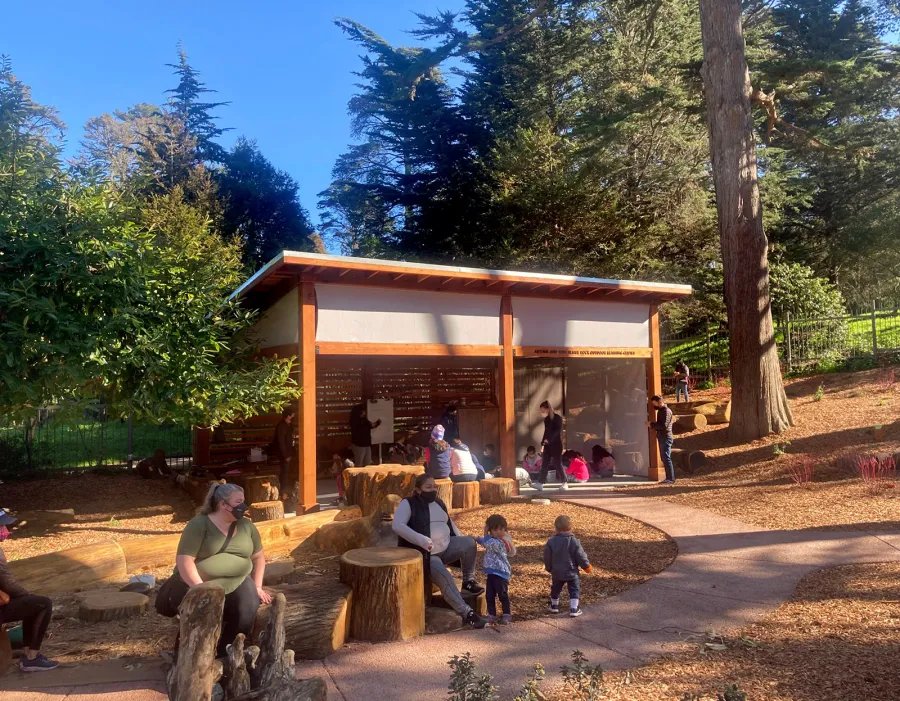 Custom Sunset Patio Pavilion (Options: 28' x 18', 1 Fixed Louvered Privacy Wall, California Redwood, No Electrical Wiring Trim, 6-Post Anchor Kit for High-Wind, No Post Decorative Trim, 9' & 12' H Posts, No Ceiling Fan Base, Curtain Rods on 3 Sides, with Fascia Boards, Transparent Premium Sealant). Supports and Rafters at Same Level by Custom Request. Photo Courtesy of California Academy of Sciences of San Francisco. CA [www.calacademy.org].
