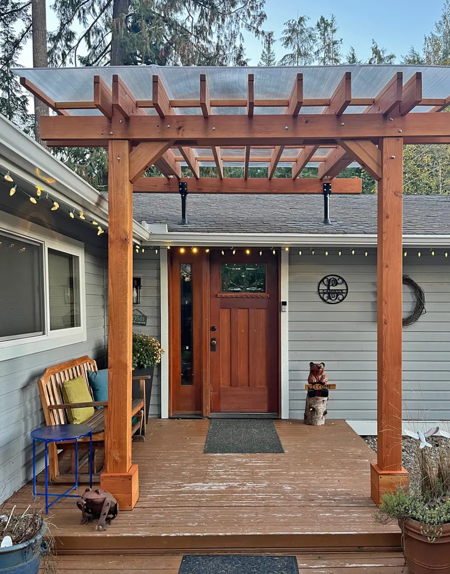 Custom Sunset Patio Pavilion (Options: 10' L x 9'-8" W, No Privacy Panels, Douglas-fir, No Electrical Wiring Trim, 2-Post Anchor Kit for Concrete, with Roof Risers by Custom Request, 10' H Posts, No Post Decorative Trim, with Transparent Polycarbonate Roofing Panels Instead of the Standard Roof Boards, No Ceiling Fan Base, No Curtain Rods, Transparent Premium Sealant). Photo Courtesy of C. Cadieux of North Bend, WA.