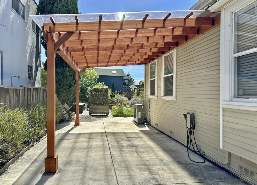 Custom Sunset Porch Pavilion (Options: 20' L x 12' W, Mature Redwood, No Electrical Wiring Trim, 2-Post Anchor Kit for Concrete, 10' H Posts, No Post Decorative Trim, with Transparent Polycarbonate Roofing Panels Instead of the Standard Roof Boards, No Ceiling Fan Base, No Curtain Rods, Transparent Premium Sealant). Photo Courtesy of M. Bualat of San Jose, CA.