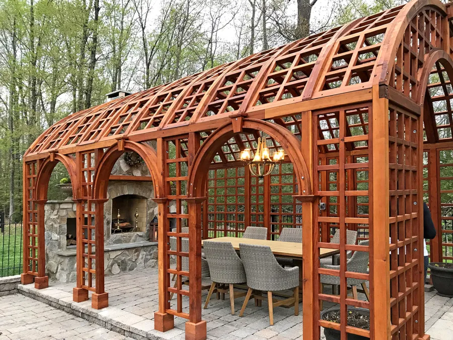 The Victorian Trellis (Options: 22' L x 14' W, Combination of Arcs and Lattice Panels, Mature Redwood, No Rain Guard, 9' Post Height, No Electrical Wiring Trim, Post Anchor Kit for Stone, No Ceiling Fan Base, Transparent Premium Sealant). Photo Courtesy of JR and Trish West of King George, Virginia.