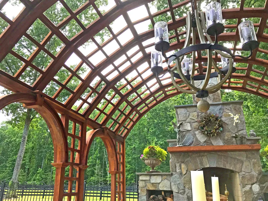 The Victorian Trellis (Options: 22' L x 14' W, Combination of Arcs and Lattice Panels, Mature Redwood, No Rain Guard, 9' Post Height, No Electrical Wiring Trim, Post Anchor Kit for Stone, No Ceiling Fan Base, Transparent Premium Sealant). Photo Courtesy of JR and Trish West of King George, Virginia.