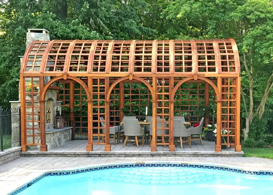 The Victorian Trellis (Options: 22' L x 14' W, Combination of Arcs and Lattice Panels, Mature Redwood, No Rain Guard, 9' Post Height, No Electrical Wiring Trim, Post Anchor Kit for Stone, No Ceiling Fan Base, Transparent Premium Sealant). Photo Courtesy of JR and Trish West of King George, Virginia.
