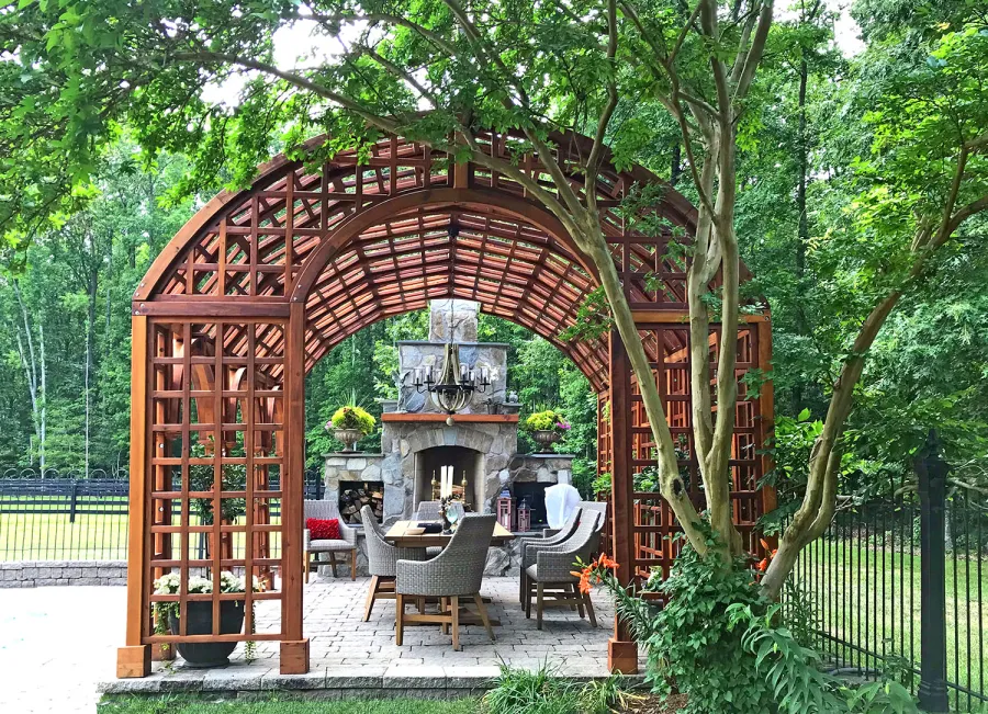 The Victorian Trellis (Options: 22' L x 14' W, Combination of Arcs and Lattice Panels, Mature Redwood, No Rain Guard, 9' Post Height, No Electrical Wiring Trim, Post Anchor Kit for Stone, No Ceiling Fan Base, Transparent Premium Sealant). Photo Courtesy of JR and Trish West of King George, Virginia.