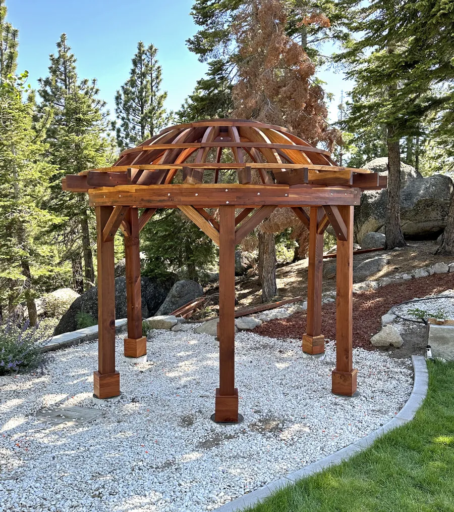Wooden Dome Pergola (Options: 12' Diameter, Without Deck, California Redwood, Open Roof with Slats at 18", 7.5' Posts, 1 Electrical Wiring Trim, 6-Post Anchor Kit for Concrete, Transparent Premium Sealant). Photo Courtesy of G. Stratton of Stateline, NV.