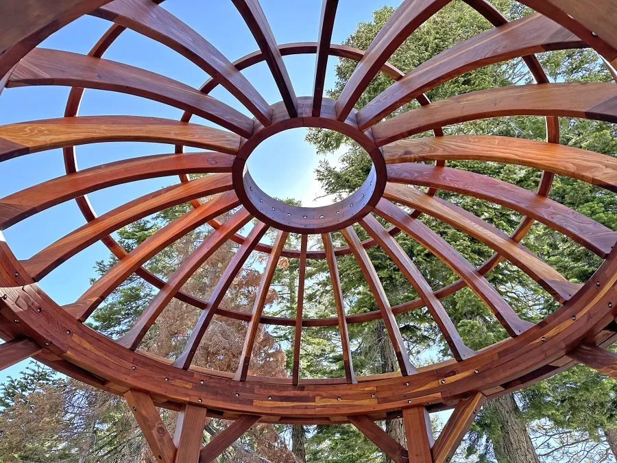 Wooden Dome Pergola (Options: 12' Diameter, Without Deck, California Redwood, Open Roof with Slats at 18", 7.5' Posts, 1 Electrical Wiring Trim, 6-Post Anchor Kit for Concrete, Transparent Premium Sealant). Photo Courtesy of G. Stratton of Stateline, NV.