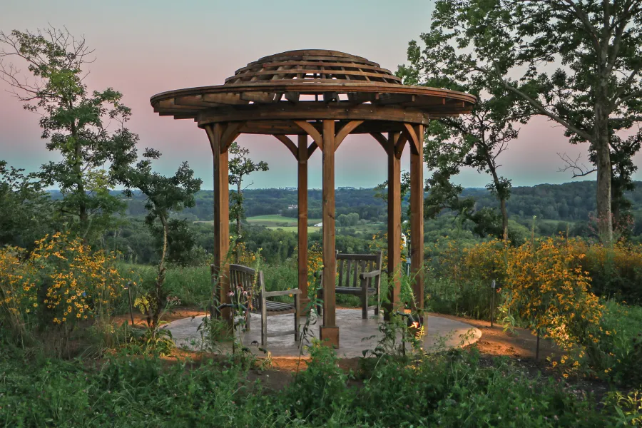 Wooden Dome Pergola (Options: 16' Diameter, Without Deck, California Redwood, Open Roof with Slats at 6", 9' Posts, No Electrical Wiring Trim, 6-Post Anchor Kit for Concrete, Transparent Premium Sealant). Photo Courtesy of P. Kawalek of Black Earth, Wisconsin.