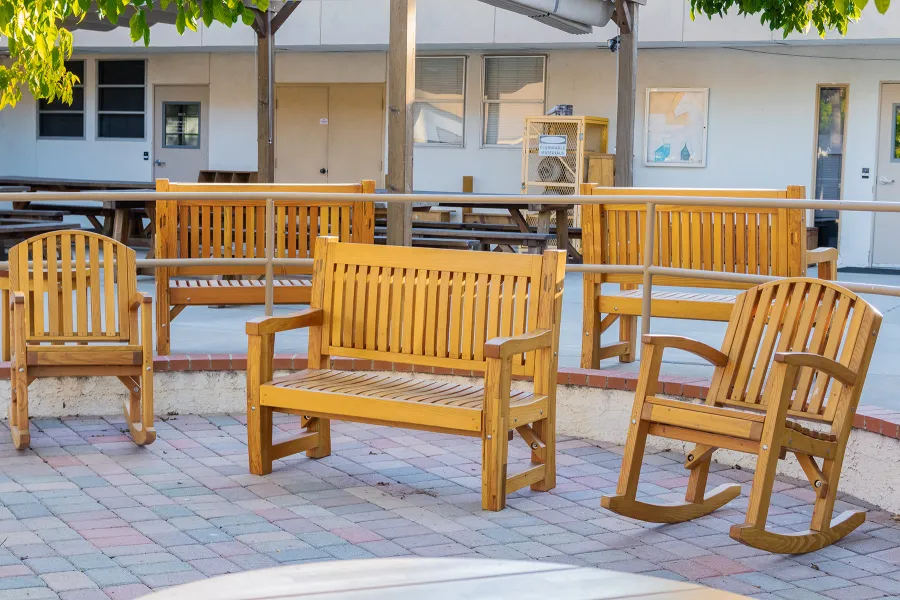 Ti Amo Benches (Options: 4 ft, Mosaic Douglas-Fir, No Cushion, No Engraving, Transparent Premium Sealant). Photo Also Shows 2 Luna Rocking Chairs. Furniture Installed in Vanguard University [55 Fair Dr, Costa Mesa, CA].