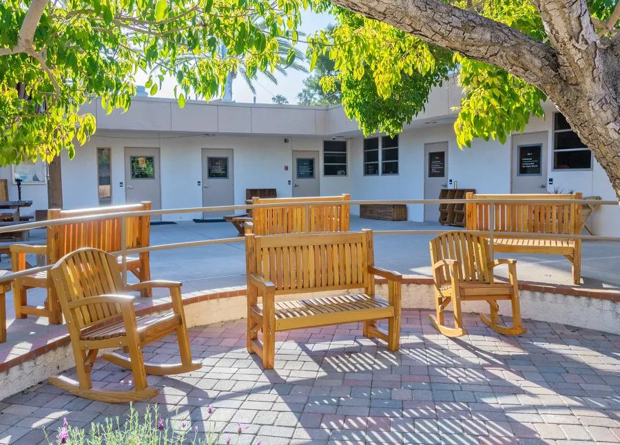 Ti Amo Benches (Options: 4 ft, Mosaic Douglas-Fir, No Cushion, No Engraving, Transparent Premium Sealant). Photo Also Shows 2 Luna Rocking Chairs. Furniture Installed in Vanguard University [55 Fair Dr, Costa Mesa, CA].