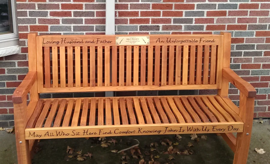 Ti Amo Benches (Options: 6 ft, Mature Redwood, No Cushion, Custom Engraving, Custom Plaque Provided by Customer, Transparent Premium Sealant). This customer photo shows how you can combine using our Engraving option with a Plaque that you can have made locally or via our Engraving partner in Santa Rosa, CA, Jay's Engraving.