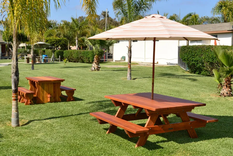 Trestle Natural Wood Outdoor Table (Options: 5' L, 34 1/2'' W Tabletop, Side Benches, Redwood, Standard Tabletop, No Umbrella Hole, Slightly Rounded Corners, 2 Full Length Side Benches, Transparent Premium Sealant) and Forever Picnic Table with Attached Benches.