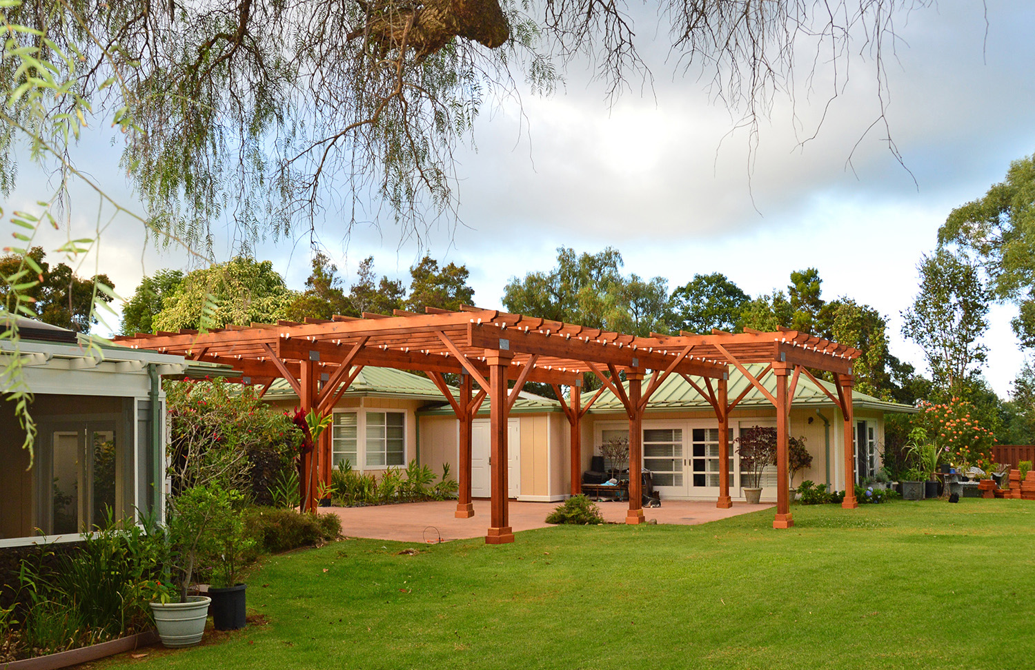 Custom Wooden Pergola (Options: 39' x 50', Mature Redwood, 3 1/8" x 15" Glulam Beams/Supports, 3 3/4" x 7 1/4" Rafters and 1 3/4" x 3 3/4" Slats, Double 5 /12" x 5 1/2" x 10' Posts, Custom Post Anchors, Transparent Premium Sealant). Photo Courtesy of D. Cole of Maui, Hawaii.