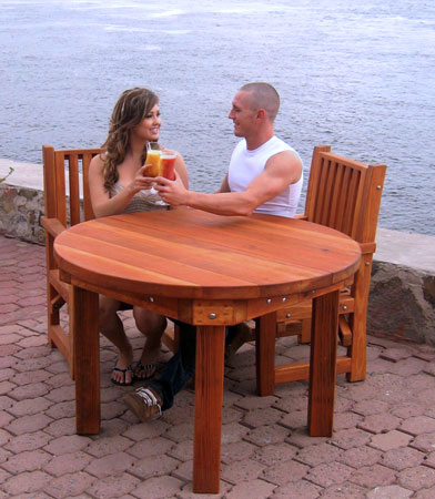 Round Outdoor Patio Table (Options: 4', 4 Chairs (only 2 shown in the picture), Redwood, Ruth Chairs, No Cushions, Arm Chairs only, Seamless tabletop, No Lazy Susan, No Umbrella Hole, Transparent Premium Sealant). 