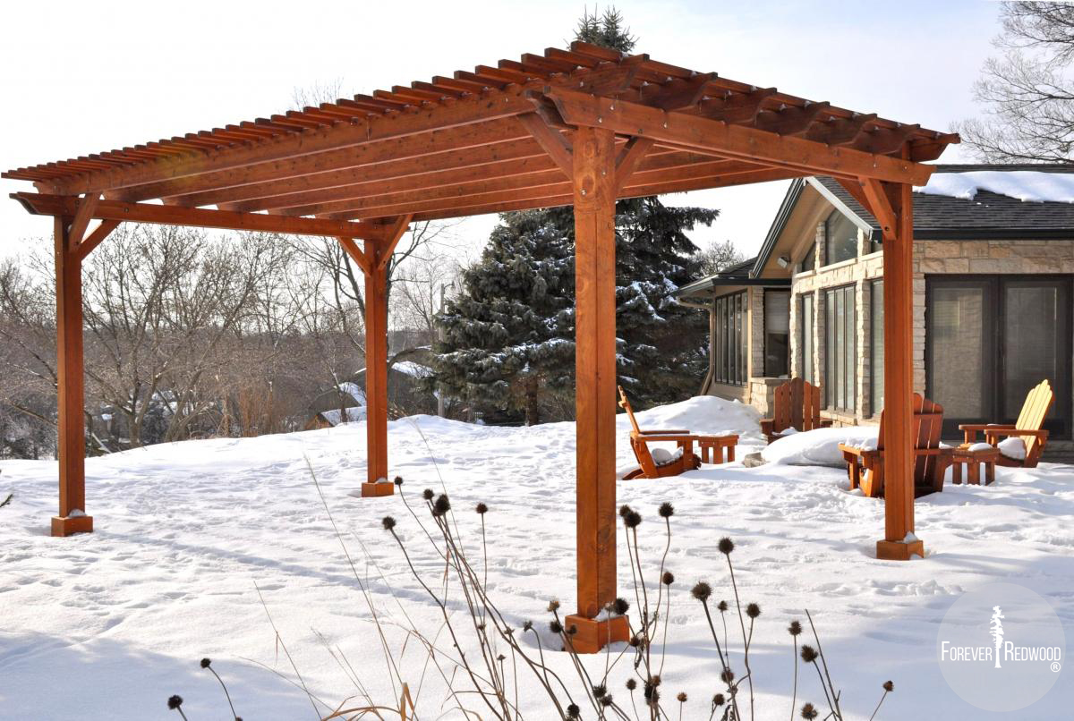 Traditional Wooden Garden Pergola (Options: 20' L x 14' W, Mature Redwood, No Electrical Wiring Trim, Slats at 6" and Rafters at 18", Lengthwise Roof Support Timbers, 4-Post Anchor Kit for Stone, No Ceiling Fan Base, No Privacy Panels, No Curtain Rods, 9' Post Height, Transparent Premium Sealant). Photo Courtesy of Mary Louise and Gerry Neugent of Des Moines, IA.