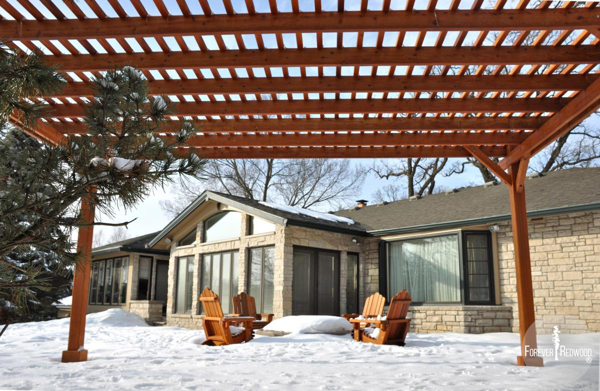 Traditional Wooden Garden Pergola (Options: 20' L x 14' W, Mature Redwood, No Electrical Wiring Trim, Slats at 6" and Rafters at 18", Lengthwise Roof Support Timbers, 4-Post Anchor Kit for Stone, No Ceiling Fan Base, No Privacy Panels, No Curtain Rods, 9' Post Height, Transparent Premium Sealant). Photo Courtesy of Mary Louise and Gerry Neugent of Des Moines, IA.
