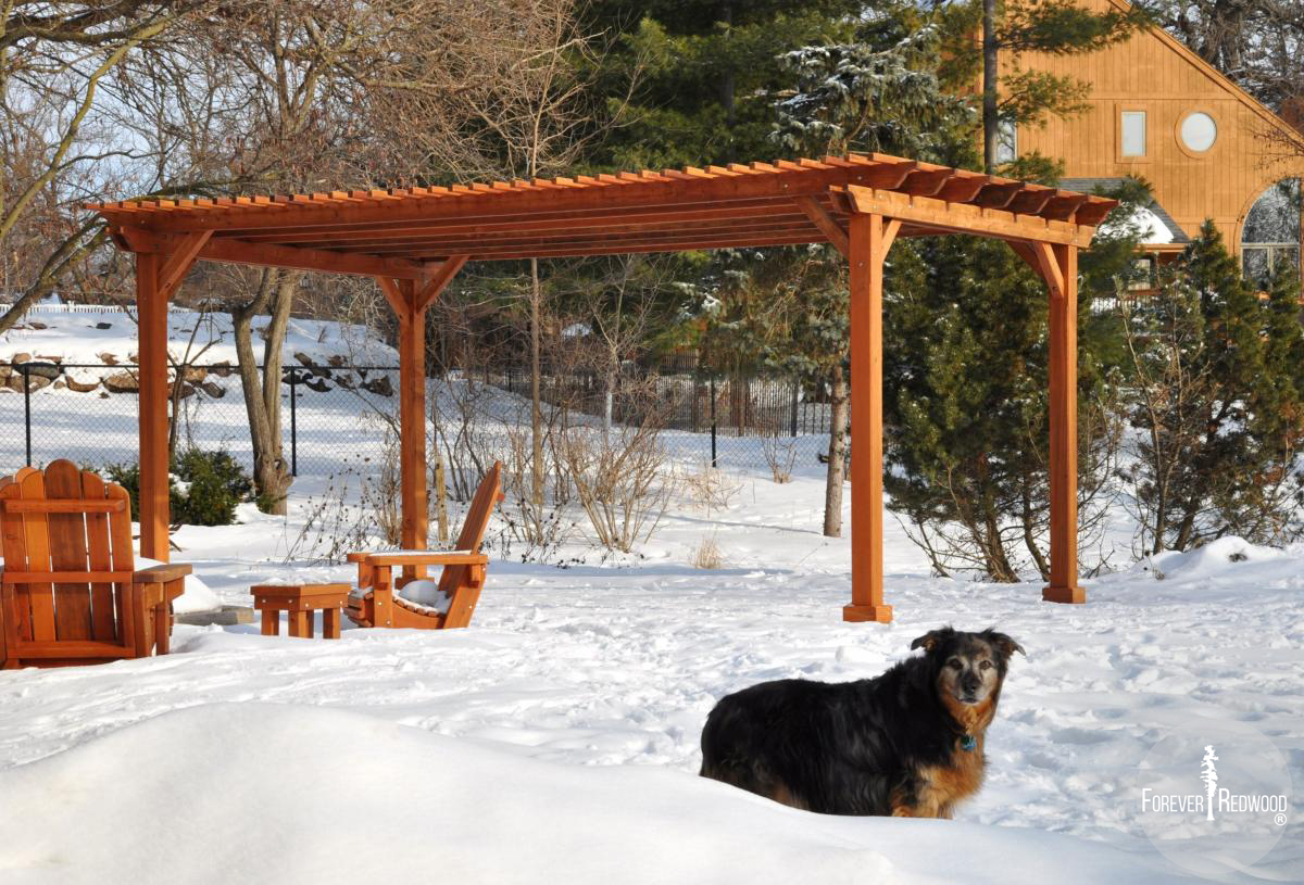 Traditional Wooden Garden Pergola (Options: 20' L x 14' W, Mature Redwood, No Electrical Wiring Trim, Slats at 6" and Rafters at 18", Lengthwise Roof Support Timbers, 4-Post Anchor Kit for Stone, No Ceiling Fan Base, No Privacy Panels, No Curtain Rods, 9' Post Height, Transparent Premium Sealant). Photo Courtesy of Mary Louise and Gerry Neugent of Des Moines, IA.