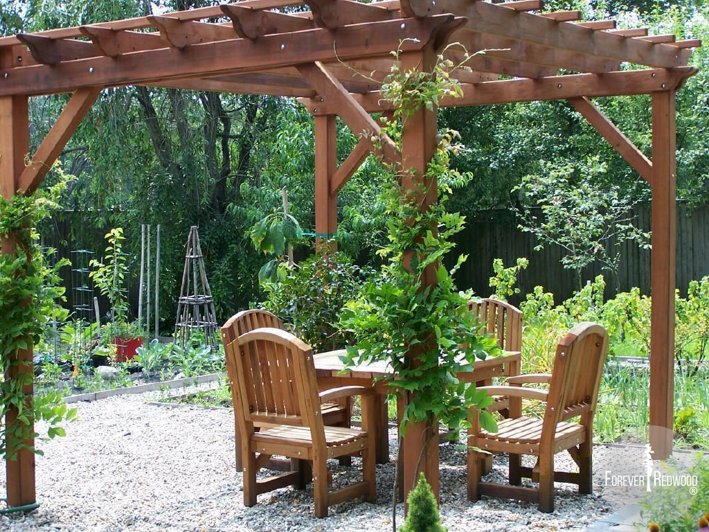 Traditional Wooden Garden Pergola (Options: 12' L x 12' W, Old-Growth Redwood, No Electrical Wiring Trim, Open Roof with Slats at 18", Rafters at 18", 4 Post Anchor Kit for Stone, No Ceiling Fan Base, No Privacy Panels, No Curtain Rods, 9' Post Height, Transparent Premium Sealant). 4 ft Square Patio Table Set with Luna Armchairs Under the Pergola. Photo Courtesy of Ms. Anne Eccles of Lexington, MA.