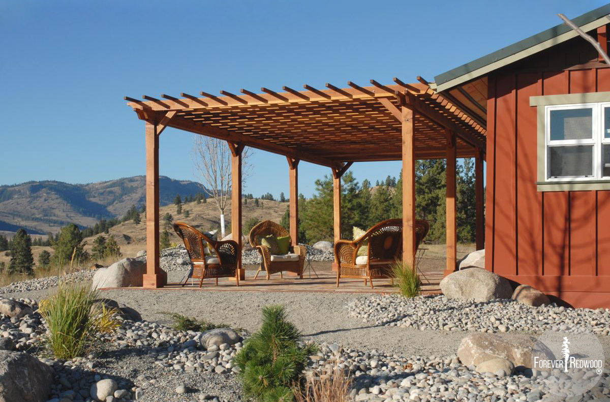 Traditional Wooden Garden Pergola (Options: 30' L x 16' W, Mature Redwood, No Electrica Wiring Trim Kit, Slats at 12" and Rafters at 18", Lengthwise Roof Support Timbers, 6-Post Anchor Kit for Concrete, No Ceiling Fan Base, No Privacy Panels, No Curtain Rods, 9' Post Height, Transparent Premium Sealant, Custom: 2 extra post). Photo Courtesy of Mr. Craig Lawrence of Renton, WA.