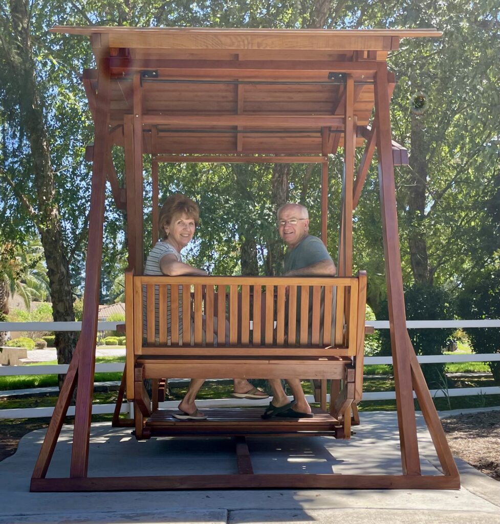 Kathy and Gary kicking back in their sturdy Dustin's Face to Face Glider.